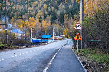 Country two lane road in the autumn forest.
