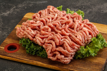 Raw pork minced meat over board