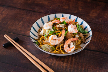 Traditional Chinese food, stir fried noodles with pork , shrimp and vegetable