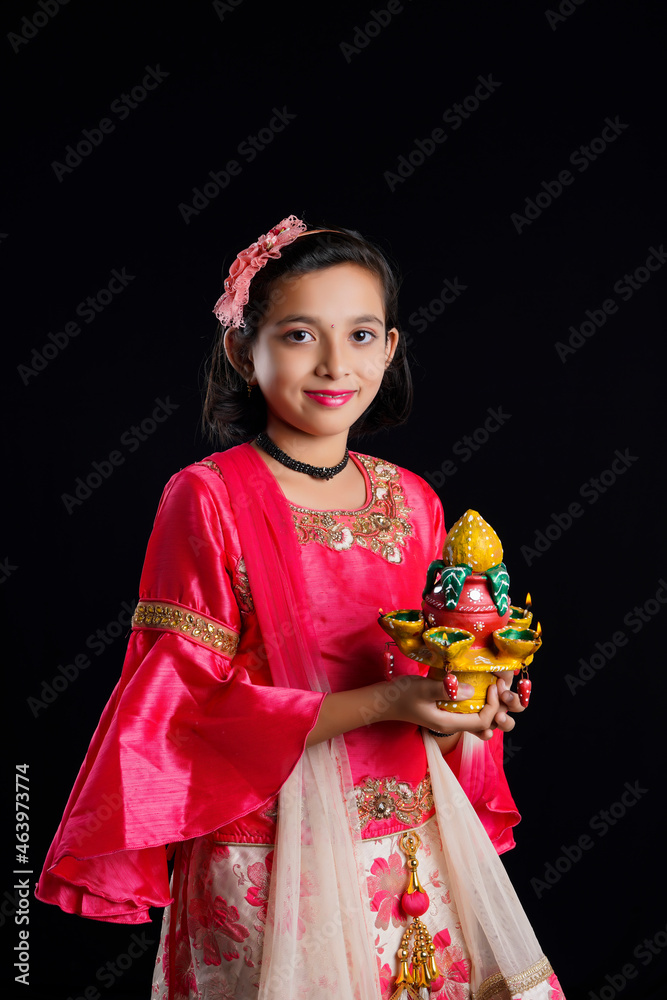 Poster Cute Indian little girl holding diya or oil lamps for Diwali Celebration.