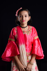 Cute indian little girl celebrating diwali festival at home.