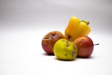 Spoiled food on the white table background