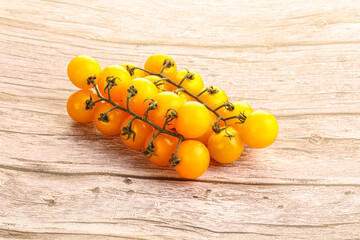 Branch with yellow cherry tomato