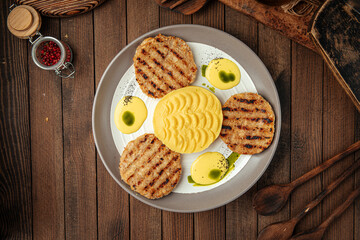 Chicken cutlets with mashed potatoes on wooden background