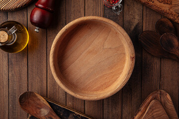 Round wooden empty bowl on the wooden rustic background