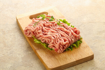 Raw minced pork meat over board