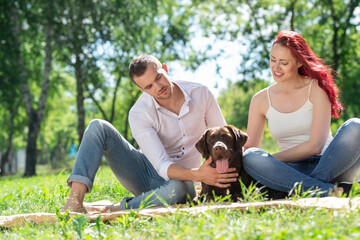 Fototapeta premium Couple with a dog in the park