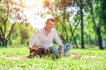 Obraz premium Young man with a dog in the park