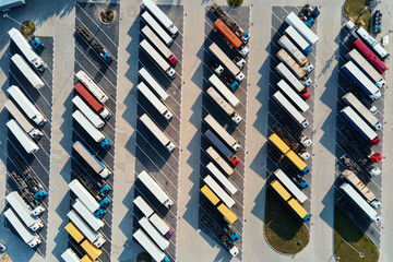 Parking lot for semi trucks, top view. Aerial view of Truck trailers parked for waiting loading on...