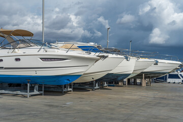Fototapeta premium Recreational boats supported on metal tripods for future restoration. S'Estanyol marina, island of Mallorca, Spain