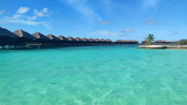 Maldives Island. Overwater villas on blue lagoon.