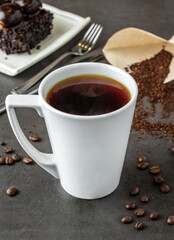 Relaxing americano coffee in white porcelain cup on stone table