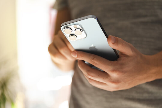 Man Using New IPhone 13 Pro In SIerra Blue Color, Close-up To Camera Set