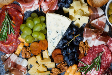 assorted cheeses, fruits and meats, top view
