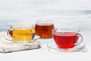 assortment of tea in glass cups on white background