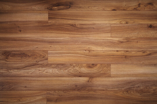 The Dark brown wooden surface parquet texture with light vignetting.