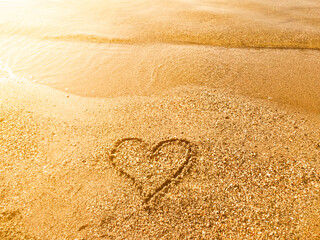 A heart is drawn on the sand