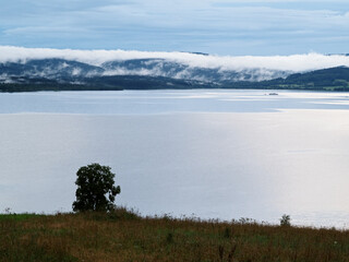 Fog over the lakeafter the storm, lake Lipno in the mountains Sumava, Czech Republic