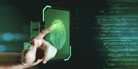 Hand pointing at glowing finger print interface on dark background with coding language. Security and biometrics concept.