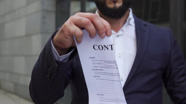 Self-confident man tearing of contract, leaving bored underpaid work, new life