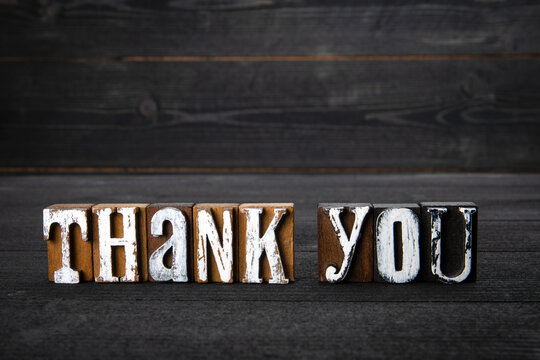 Thank You. White wooden letters on a dark wooden background