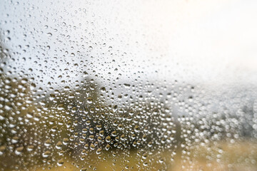 Waterdrops on window glass beginning of autumn