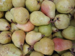 Many pears on the market, backgrounds and textures.