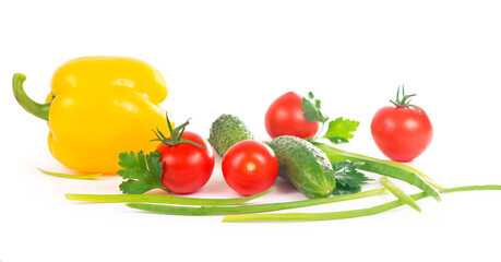 Vegetables on the white background - broccoli, tomatoes, cucumbers and green onions. Composition of vegetables on the white background