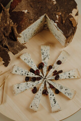 Assorted cheeses with grapes cured cheese on a serving board
