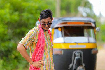 Indian auto rickshaw three-wheeler tuk-tuk taxi driver man wearing sun glasses