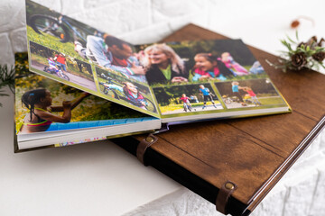 Fototapeta na wymiar photo book with wooden cover. unfolded photobook. sample photobook.