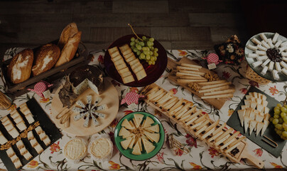 Assorted cheeses with grapes cured cheese on a serving board