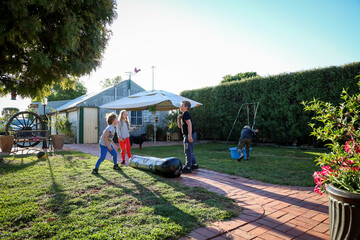 Obraz na płótnie Canvas Happy cousins having fun together in Australian backyard