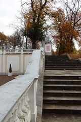 Old stairs going up by autumn season in park Kadriorg. Golden brown foliage on the back. Tallinn, Estonia. October 2021