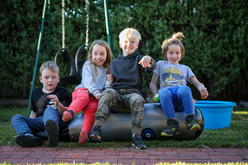 Happy cousins having fun together in Australian backyard