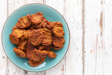 Tod Mun Pla Krai, Thai Fish Cake, deep fried fish paste balls in ceramic plate on white old wood texture background with copy space, top view, clown featherback, clown knifefish, spotted knifefish