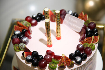 Birthday cake with decorations. Festive cake with fruit and an inscription in Ukrainian 