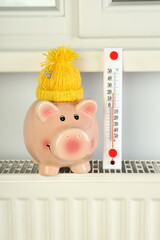 Concept of heating season with piggy bank on radiator