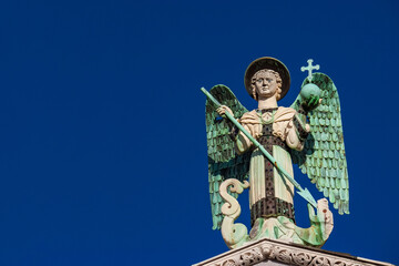 Saint Michael the Archangel defeats the Dragon, a medieval 13th century statue a the top of St...