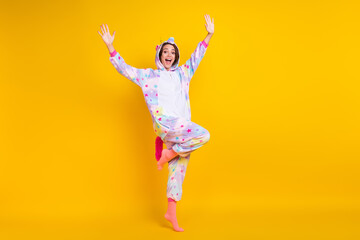 Fototapeta na wymiar Full length body size photo woman in unicorn costume smiling happy isolated bright yellow color background