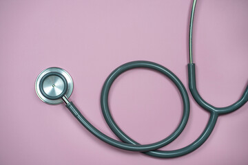 Closeup Stethoscope on pastel pink background with copy space, Health concept.