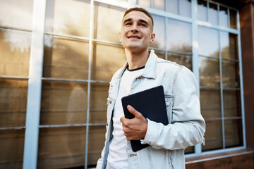 Portrait of handsome young casual man walking on the street