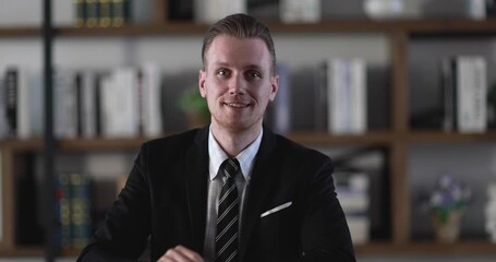 Smart CEO look businessman pays attention to speaker via webcam in online meeting session. Headshot young executive manager listen and raise a hand for asking question then stay listen answer.