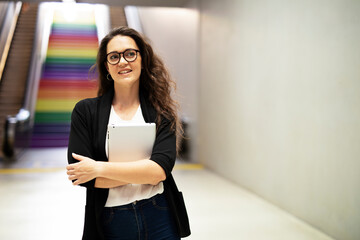 Portrait of beautiful businesswoman holding digital tablet. Young student learning online