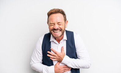 middle age handsome man laughing out loud at some hilarious joke