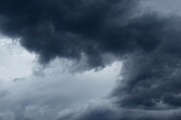 Dark grey threatening thunderclouds, rain clouds in the dark sky, weather change, summer thunderstorms, thunderclouds and rain clouds dark and grey, grey sky