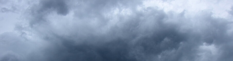 Dark grey threatening thunderclouds, rain clouds in the dark sky, weather change, summer thunderstorms, thunderclouds and rain clouds dark and grey, grey sky