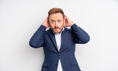 middle age handsome man feeling stressed, anxious or scared, with hands on head. businessman concept