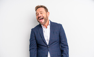 middle age handsome man with cheerful and rebellious attitude, joking and sticking tongue out....