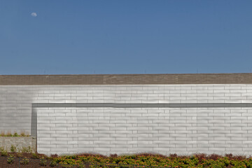Fototapeta na wymiar Bright white brick pattern wall beautiful landscaping